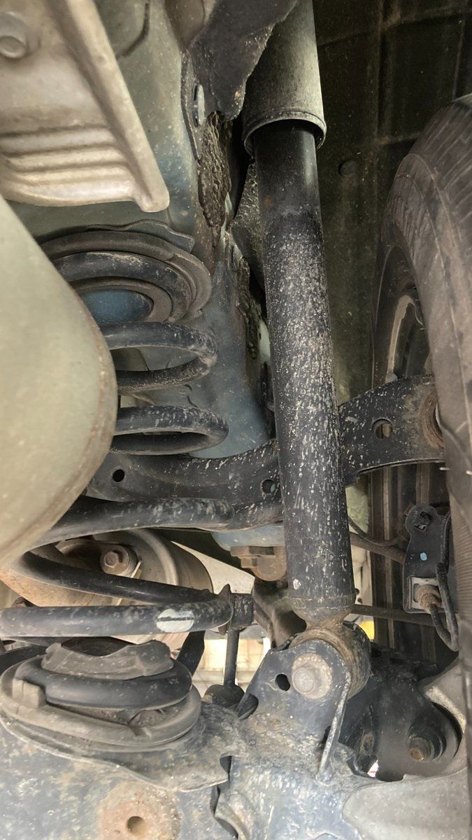 A close up of a shock absorber on a car.