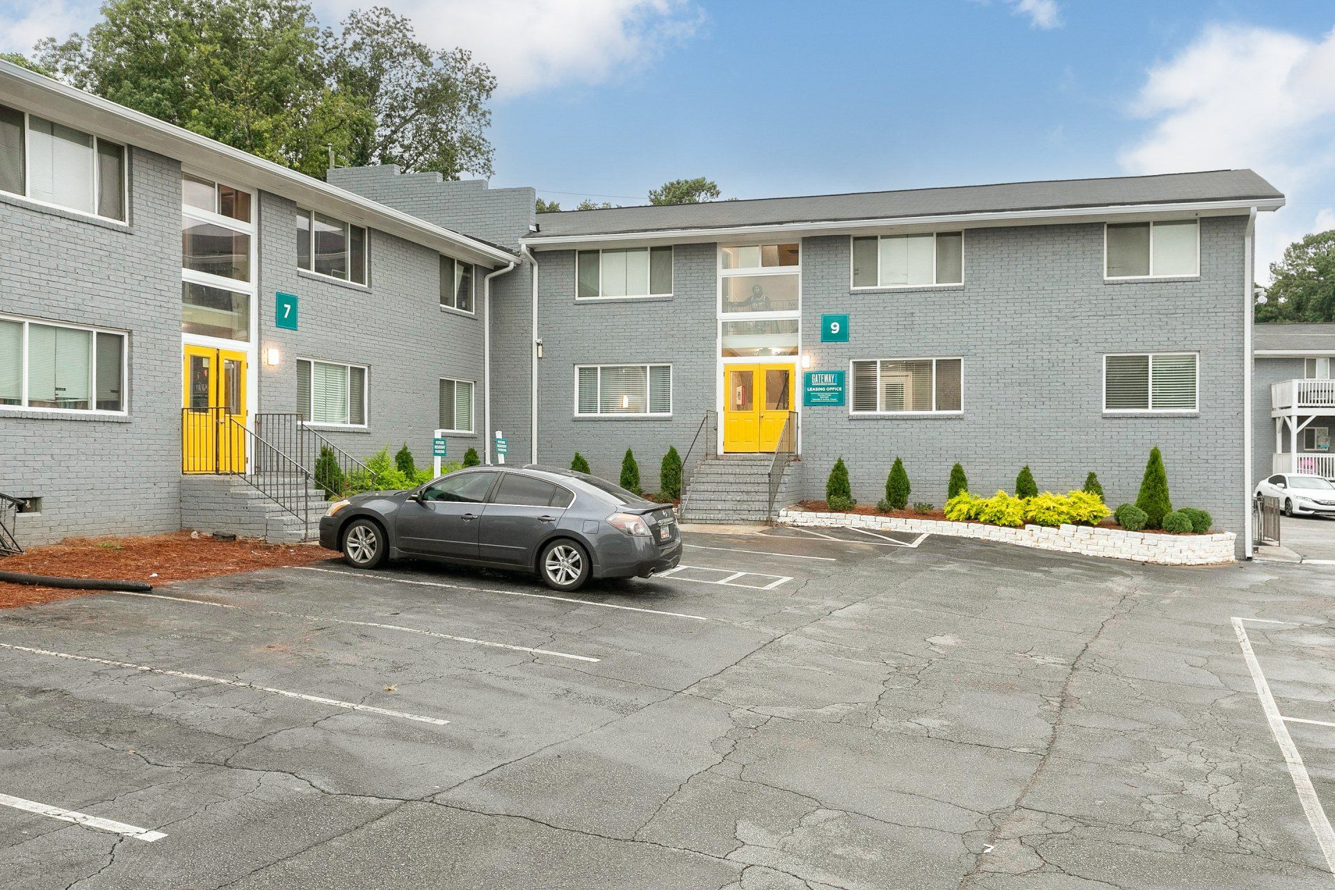 Dog-Friendly Apartments In Sylvan Hills, GA - Gateway South - Parking Spaces In Front Of Apartment Buildings.
