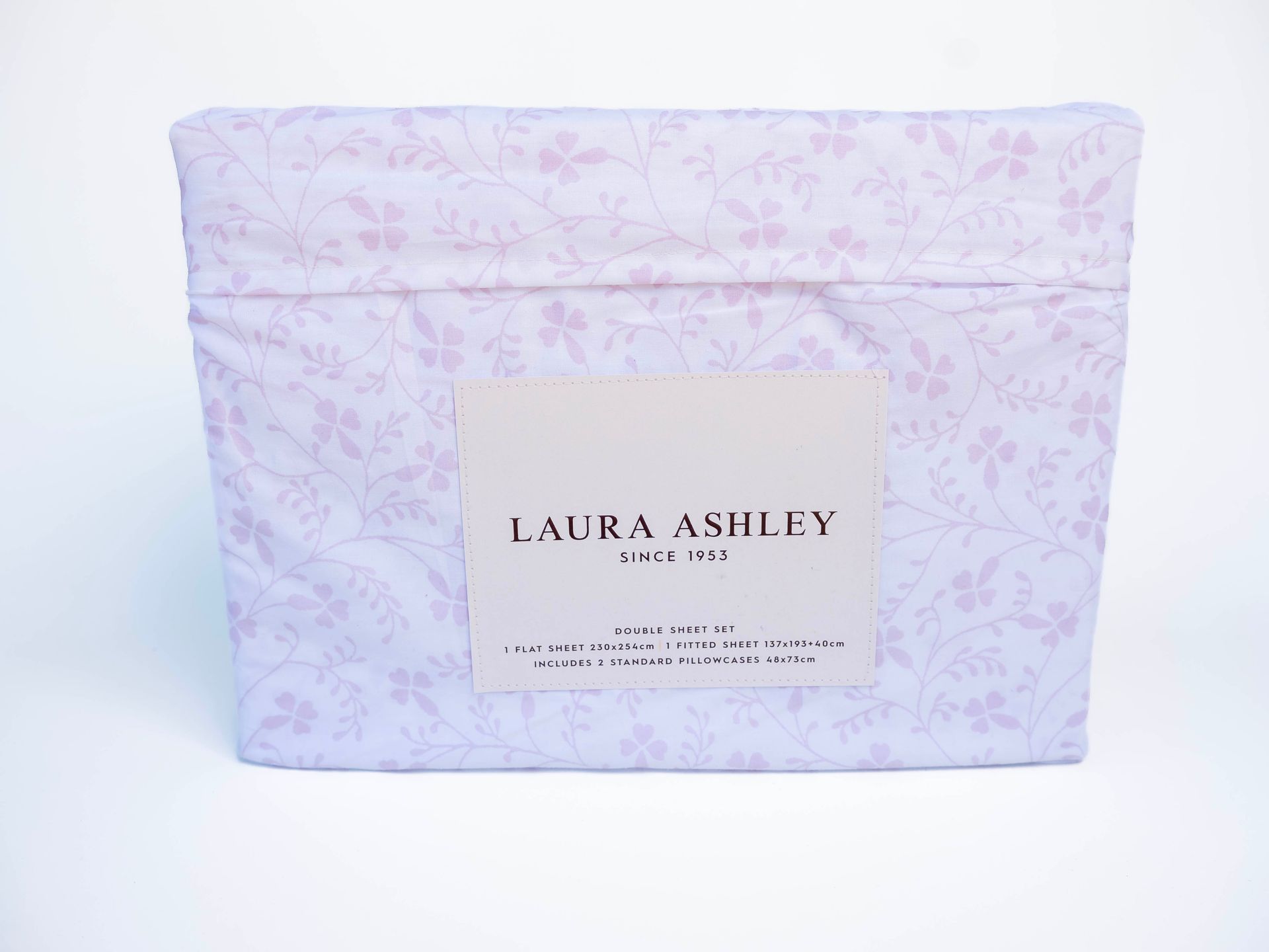 Folded bed sheet set in blue floral print with a Laura Ashley label.