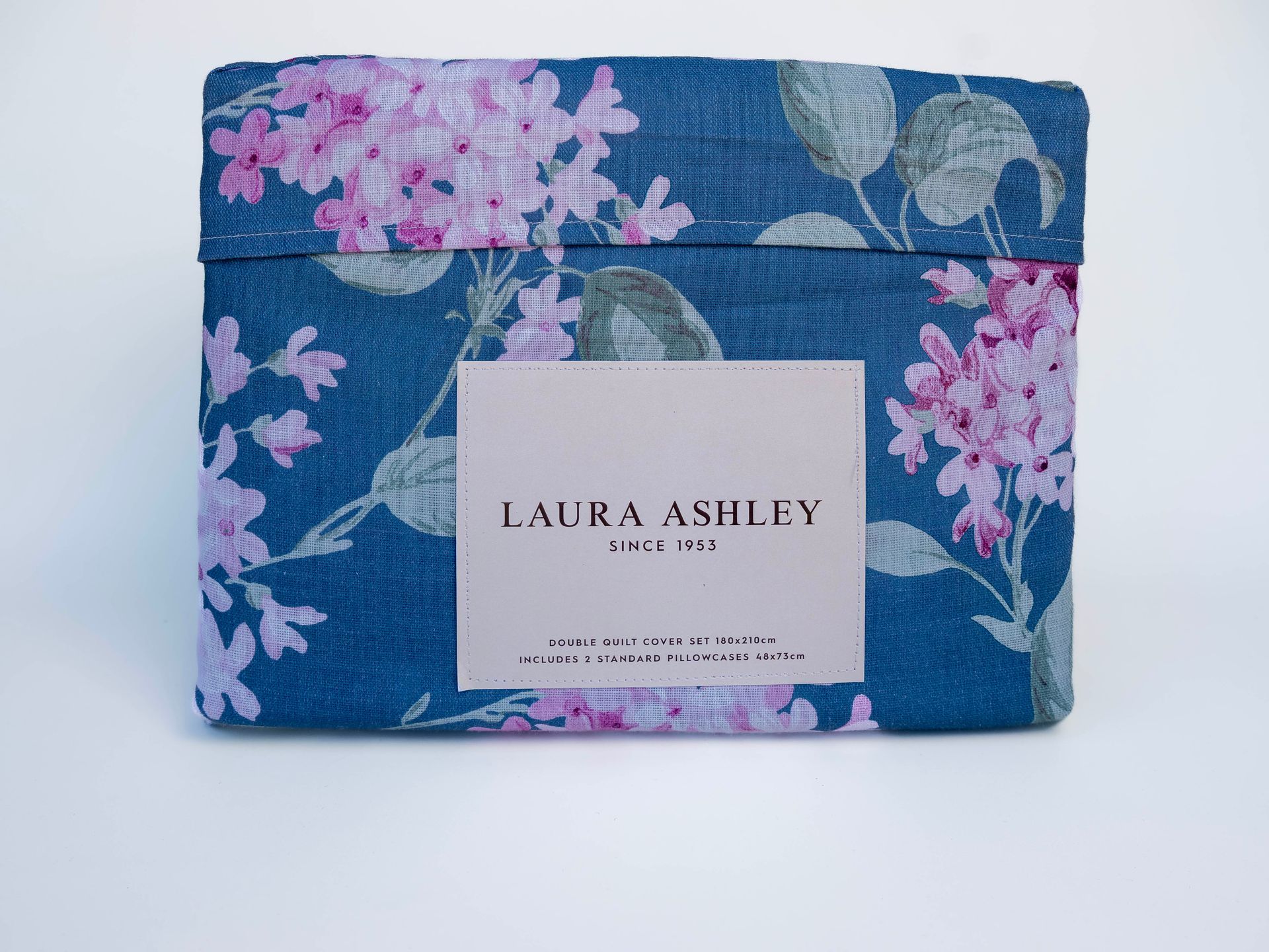 Folded Laura Ashley lilac floral bed sheet set.
