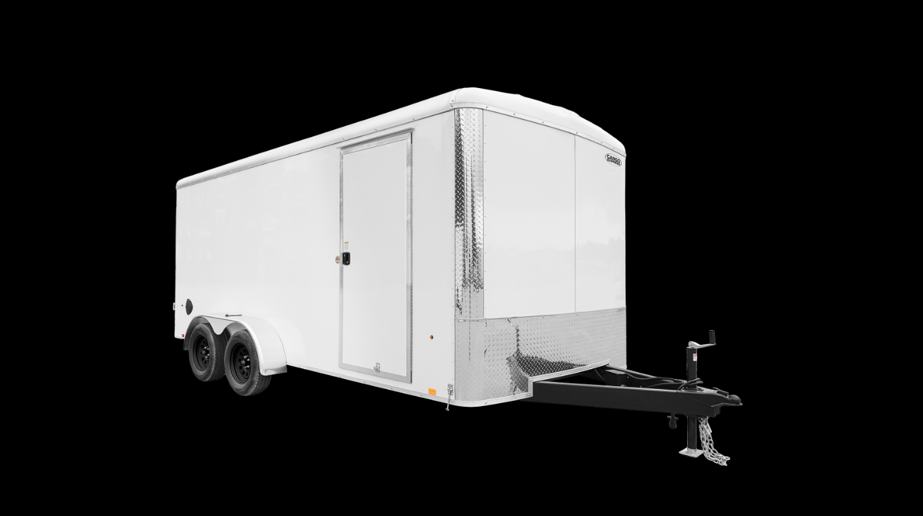 A white container with blue doors is parked in front of a house.