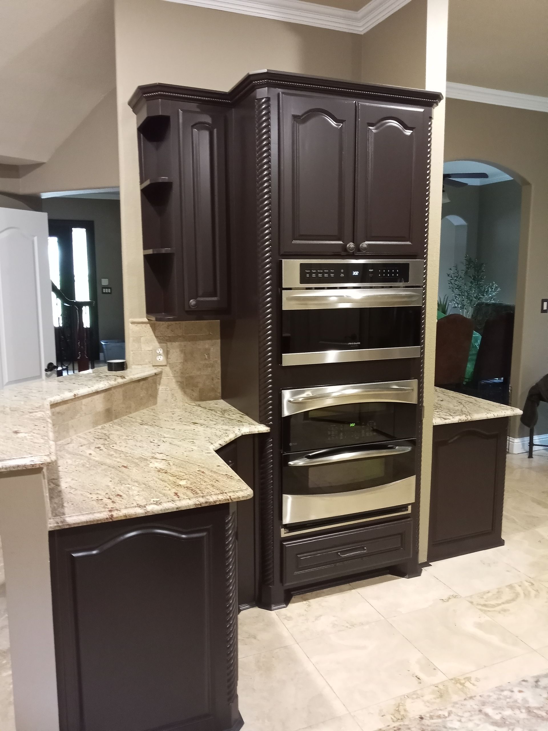 A kitchen with brown cabinets and stainless steel appliances