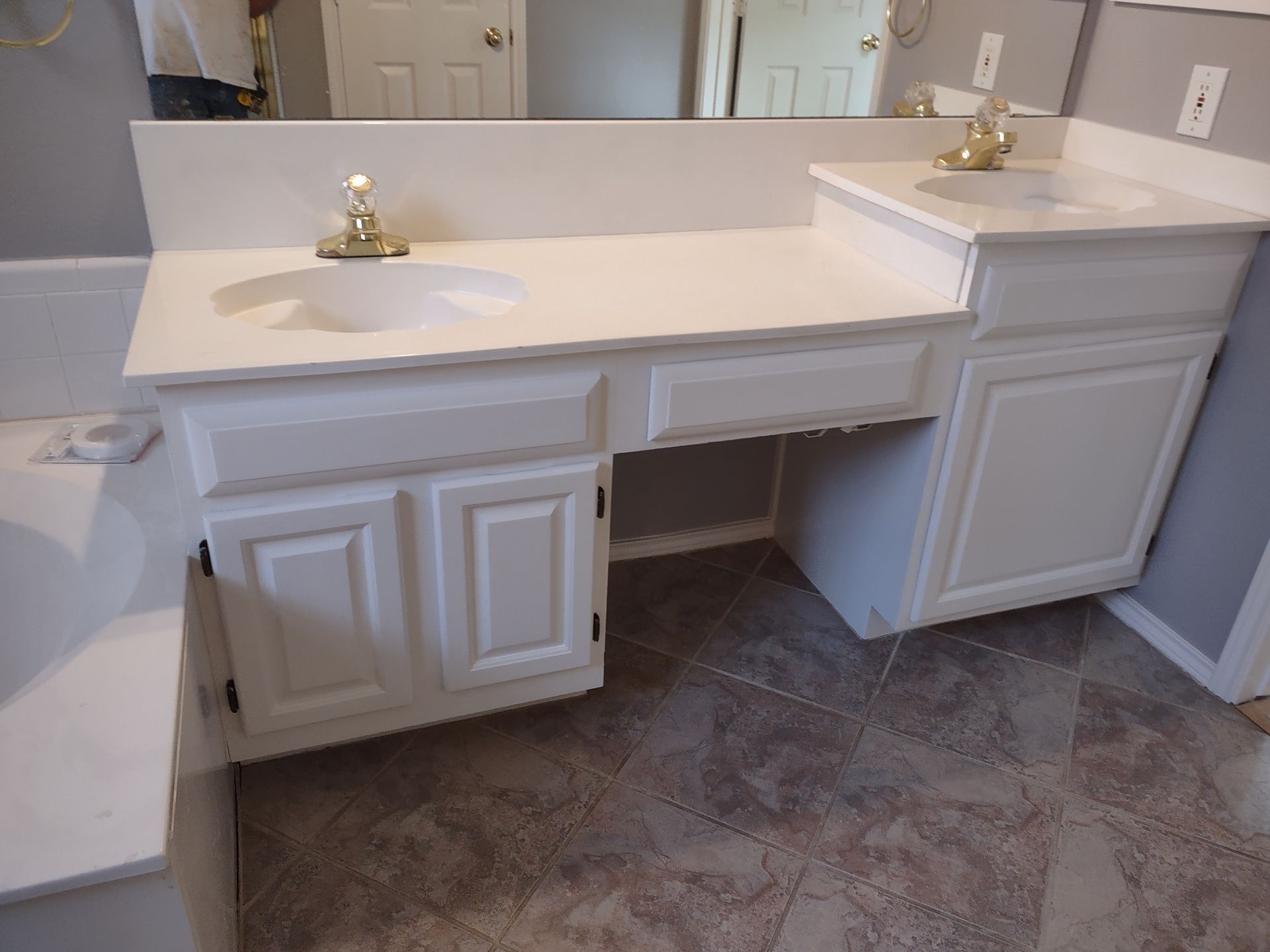 A bathroom with two sinks and a mirror