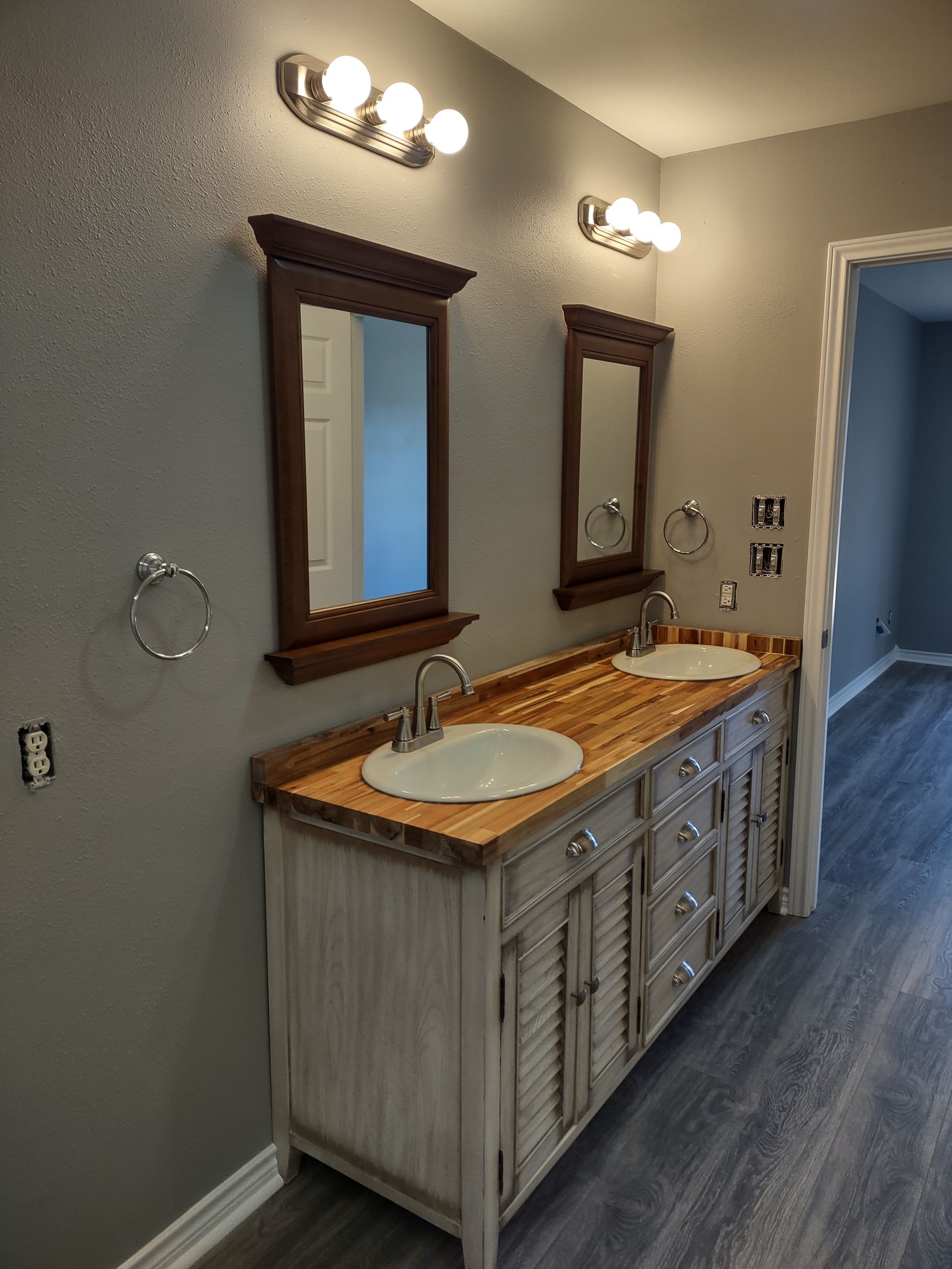 A bathroom with two sinks and two mirrors.