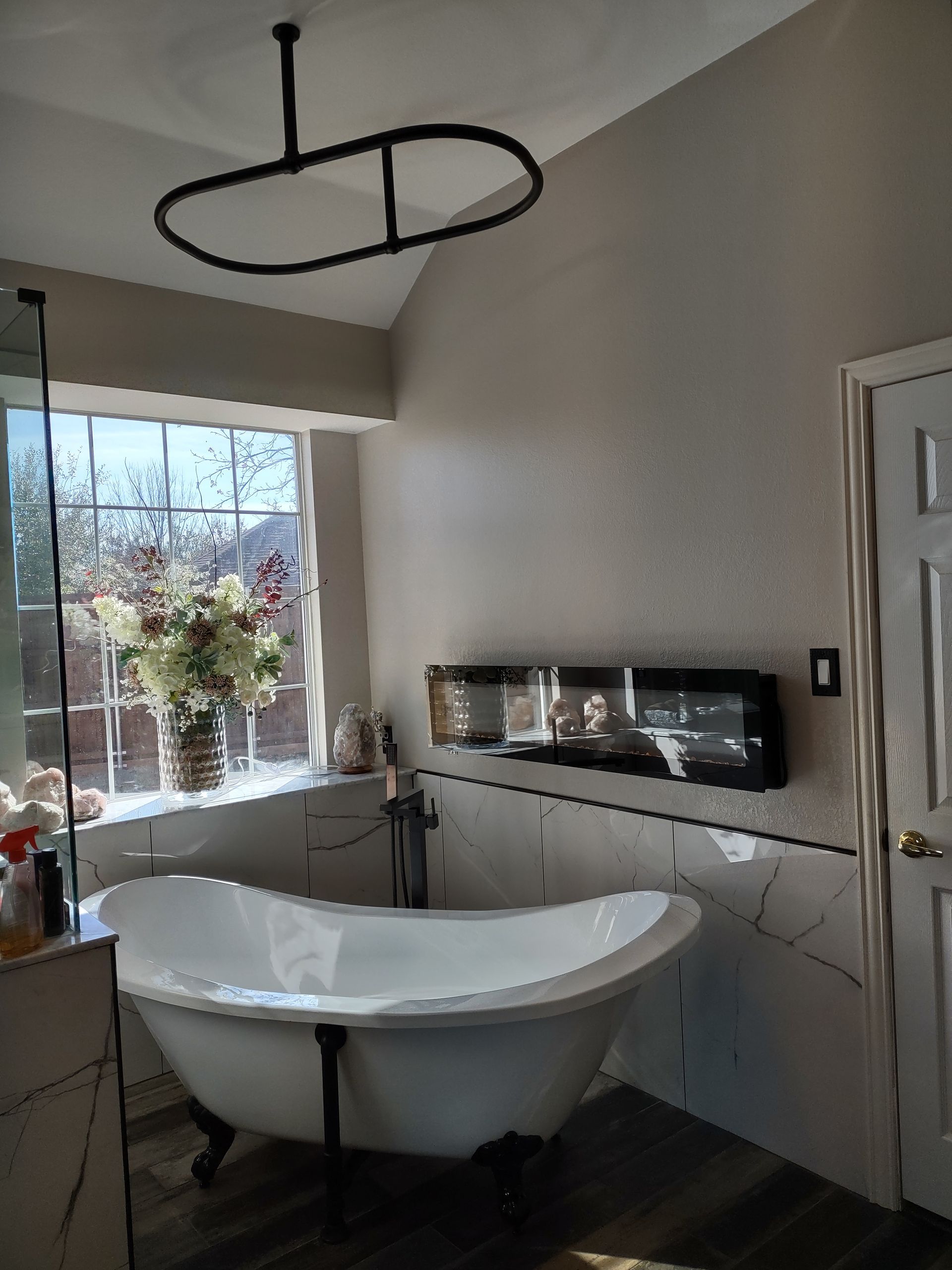 A bathroom with a claw foot tub and a window