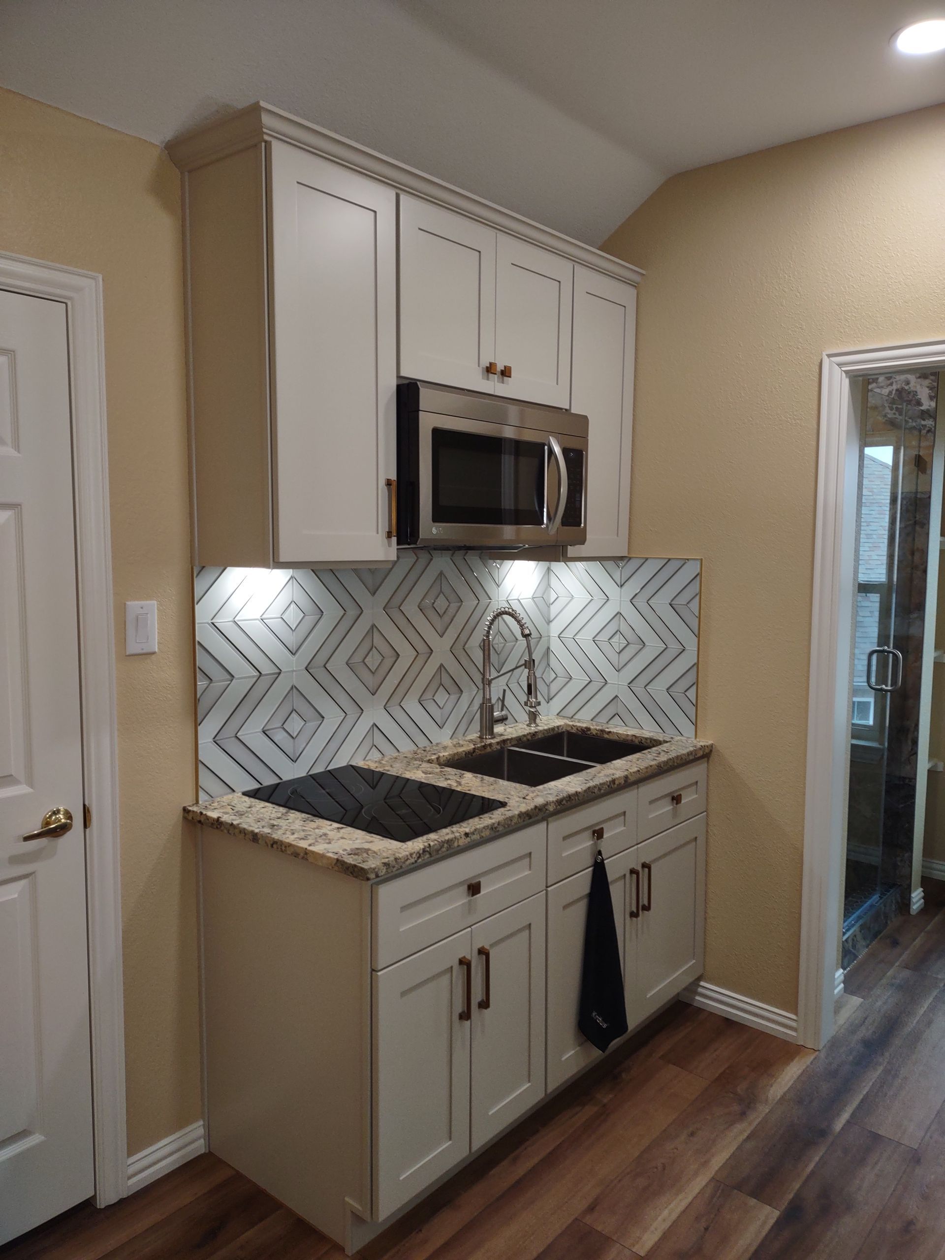 A kitchen with stainless steel appliances and white cabinets