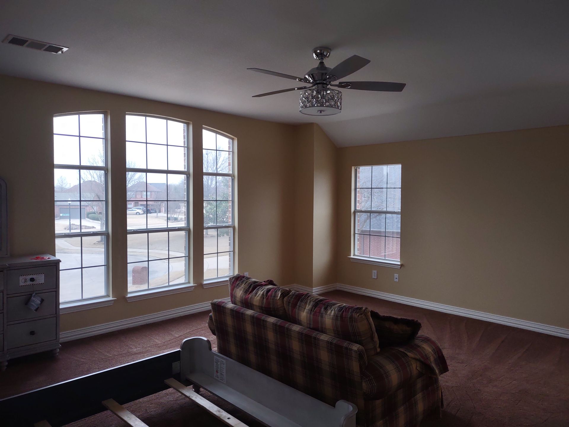 A living room with a couch and a ceiling fan