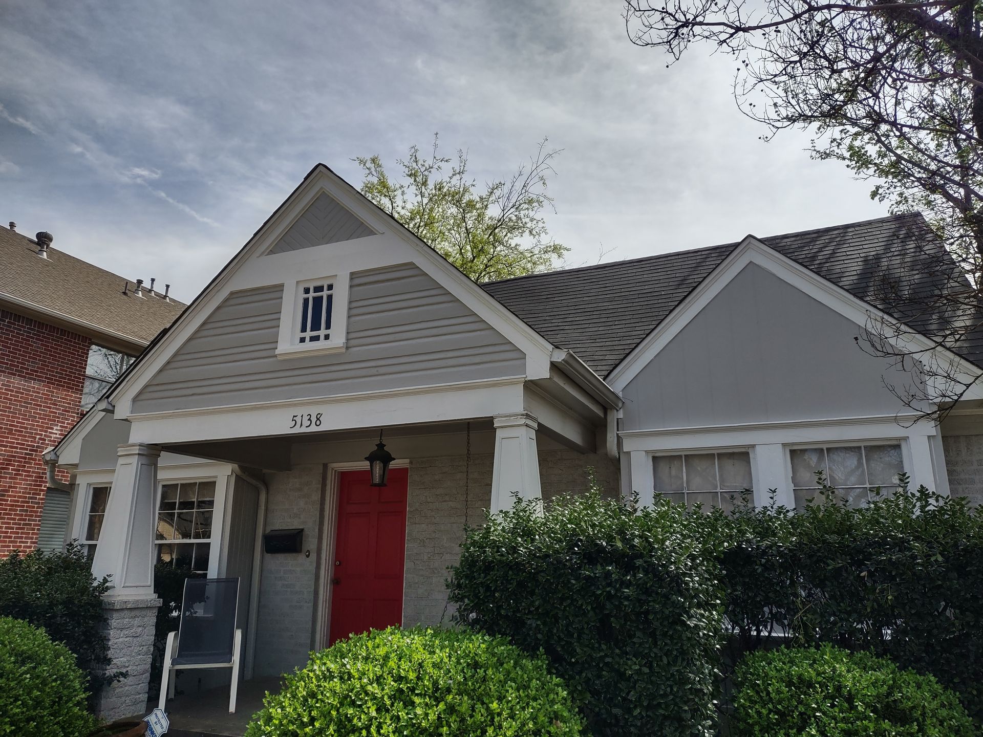 A house with a red door and a white porch