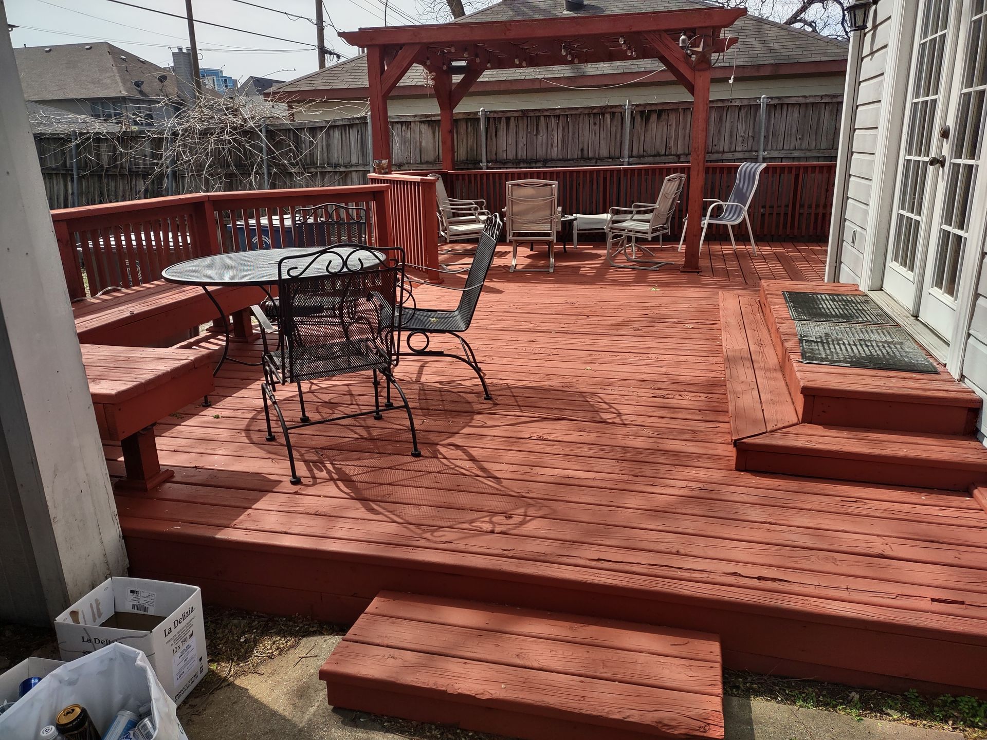 A wooden deck with a table and chairs on it