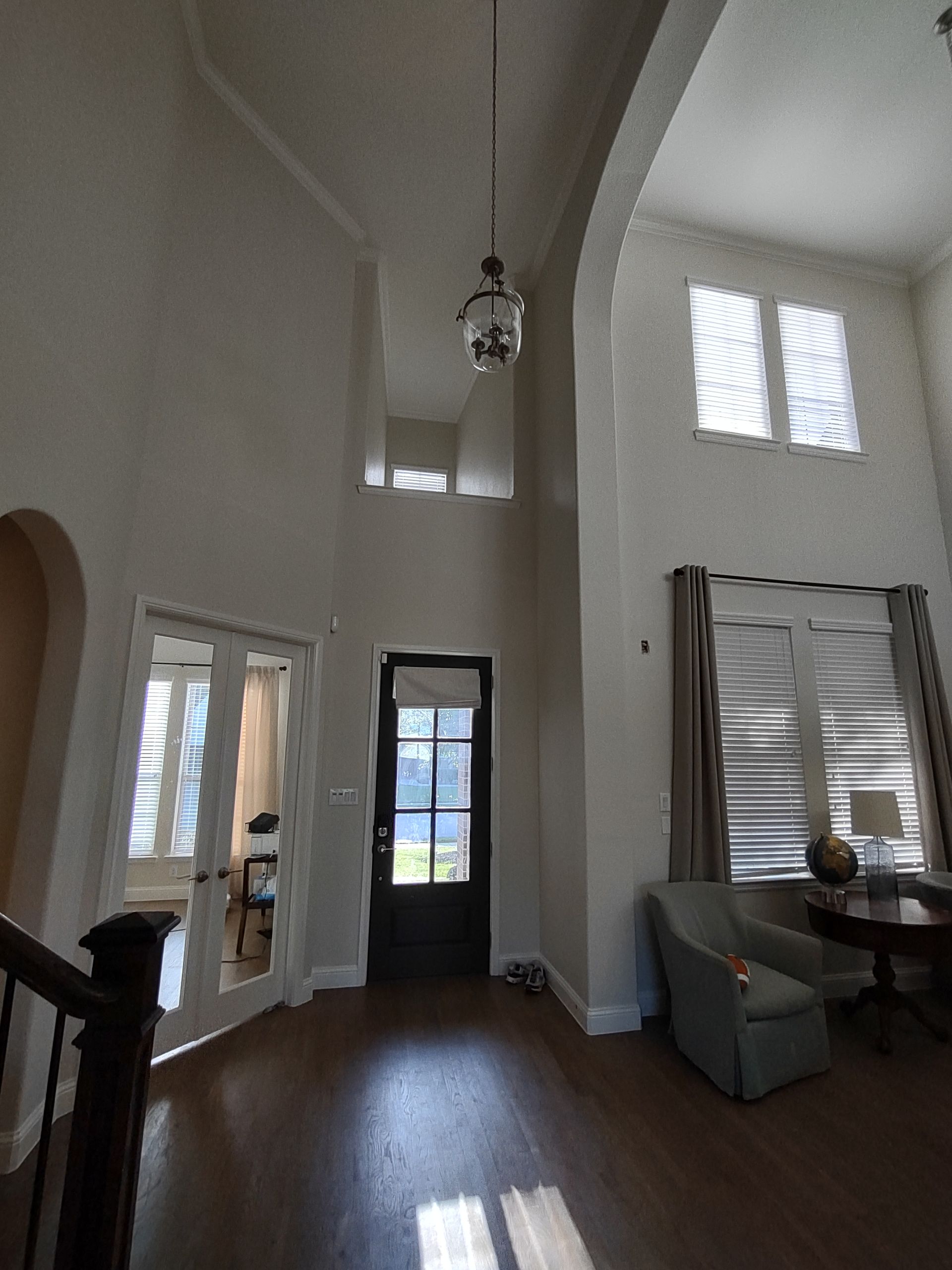 A living room with a staircase leading to the second floor