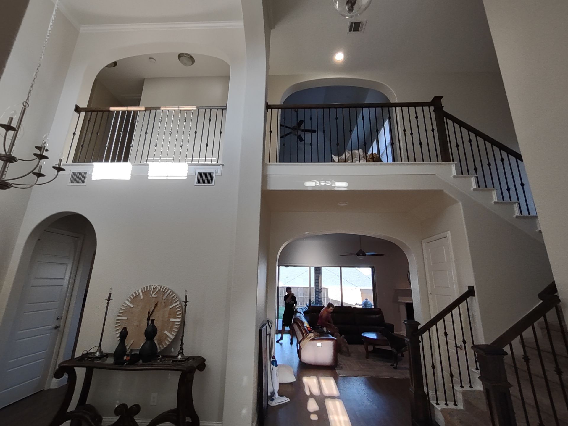 The inside of a house with a balcony and stairs