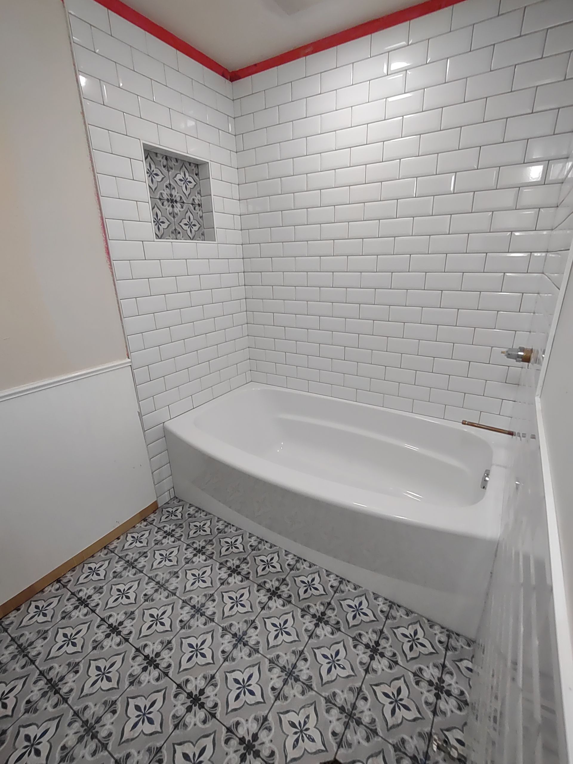 A bathroom with a bathtub and a shower.