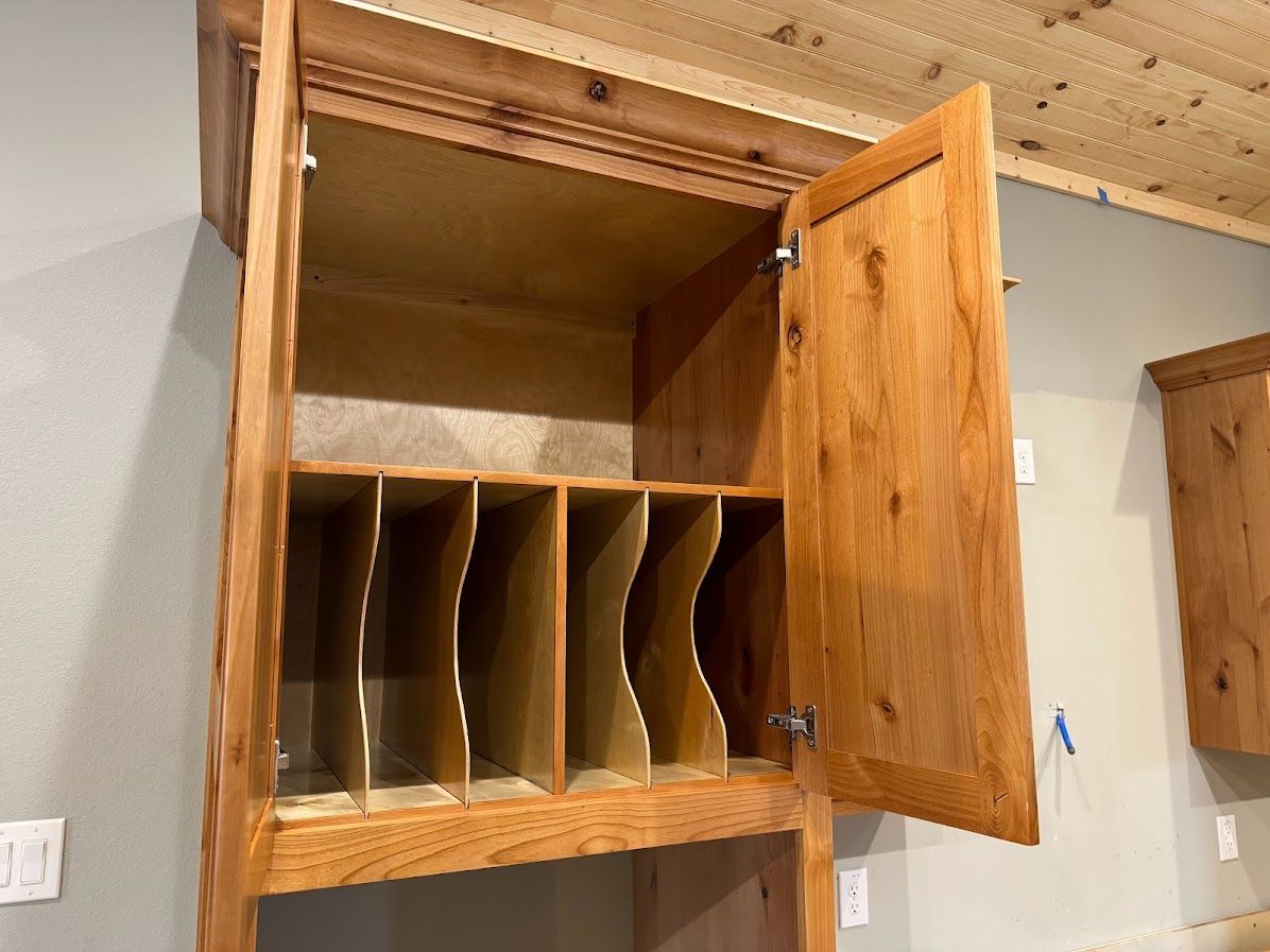 The inside of a wooden cabinet with the door open.