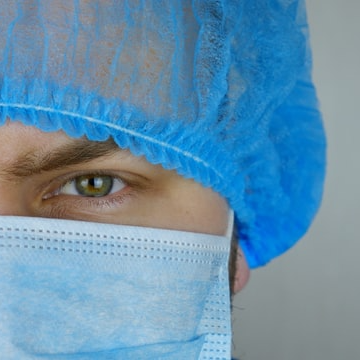 male doctor wearing hairnet and face mask
