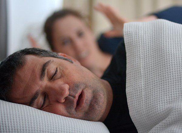 Husband snoring with frustrated wife - sleep apnoea and snoring help