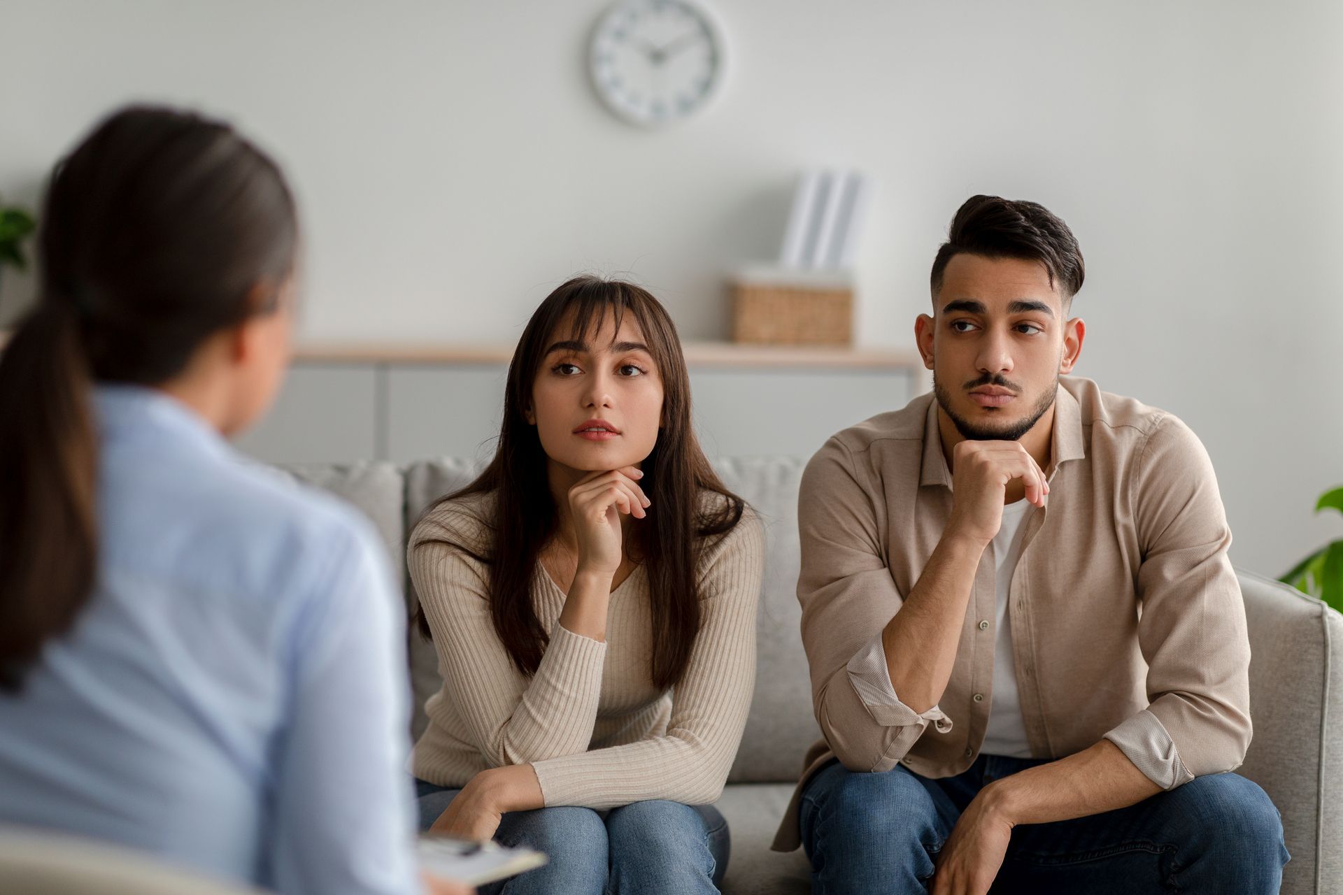 The same couple look inquisitively at their counselor wondering Does Marriage Counseling Work