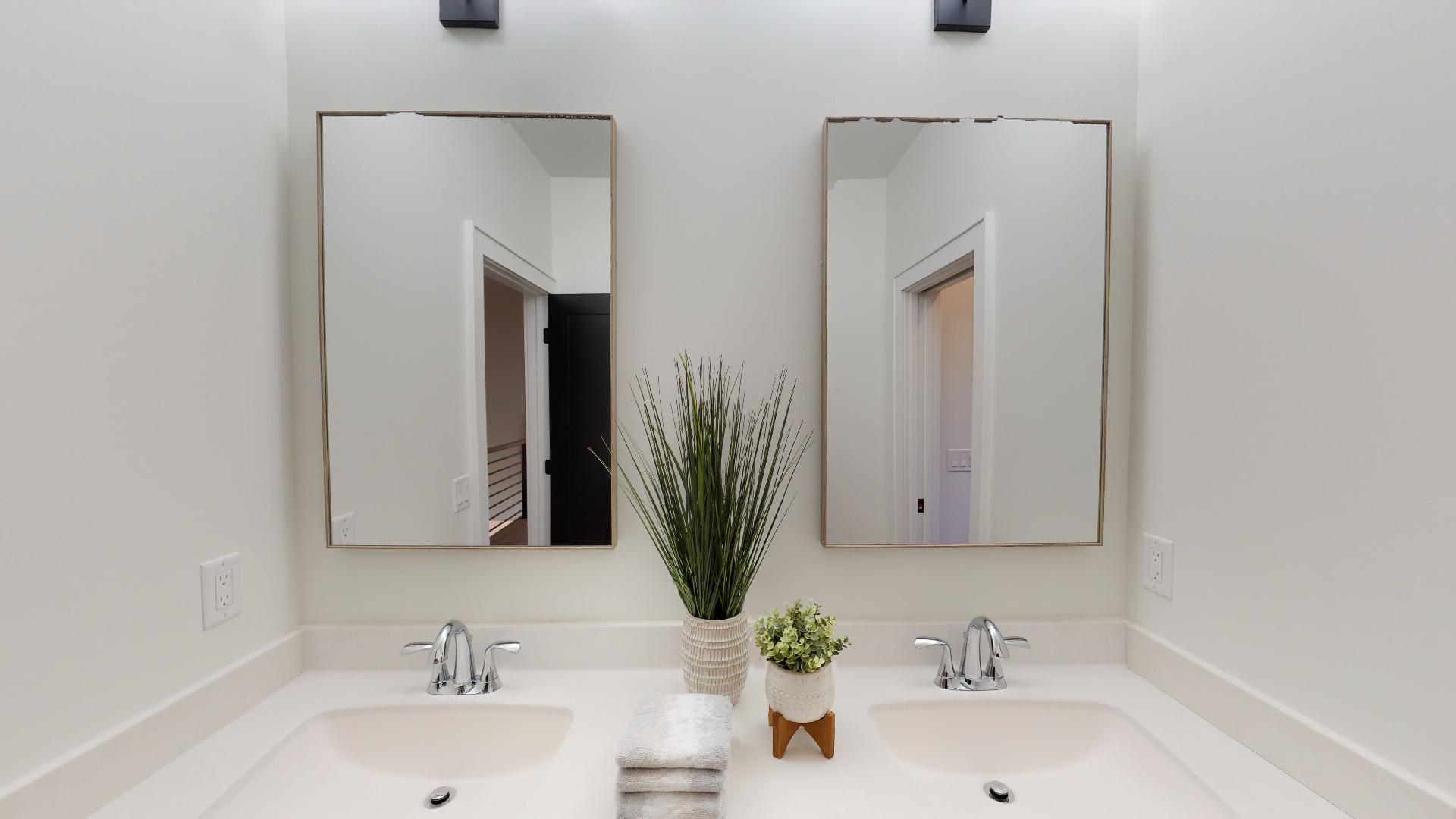 A bathroom with double vanity sink and mirror