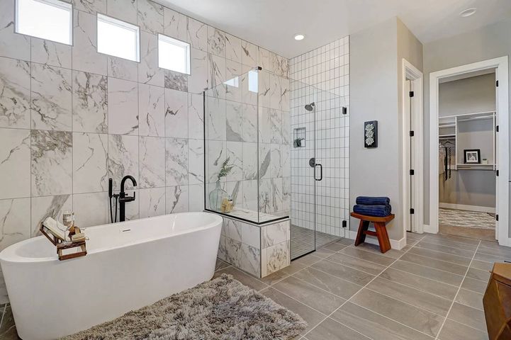 A bathroom with a bathtub and shower