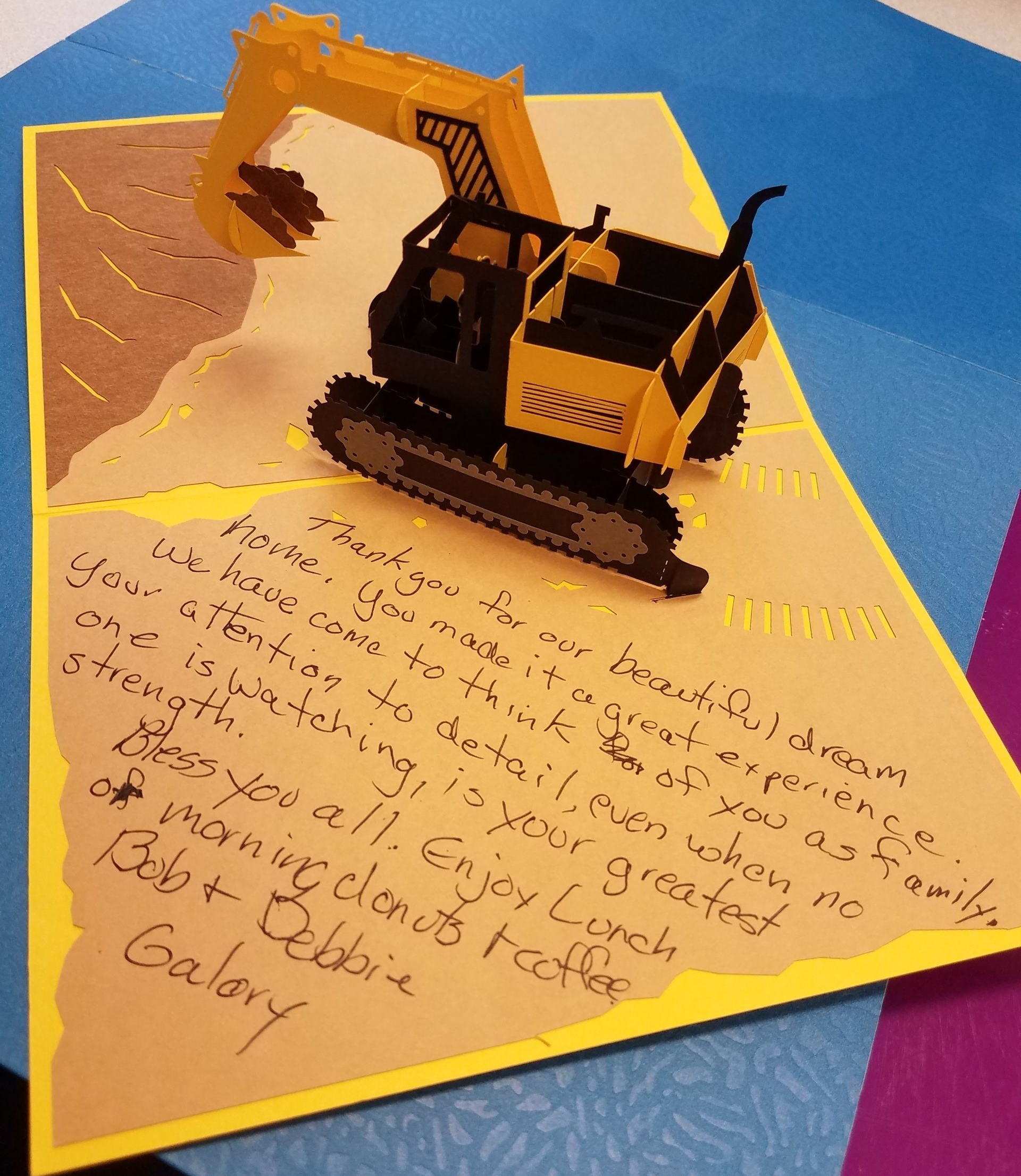 A close up of text on a card with a dump truck popout