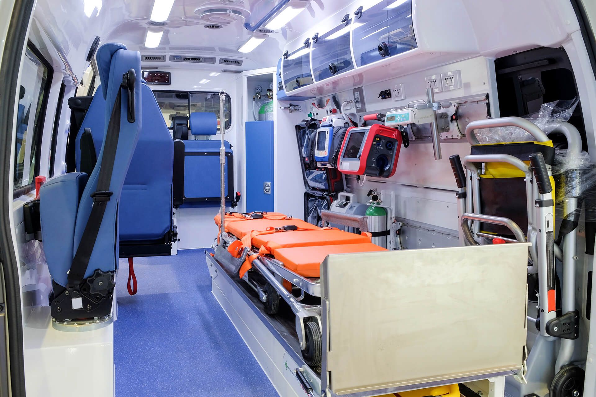 The inside of an ambulance with a stretcher in the back