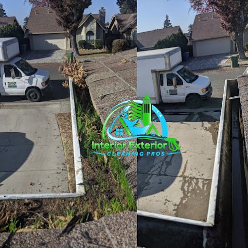 A white truck is parked on the side of the road in front of a house.