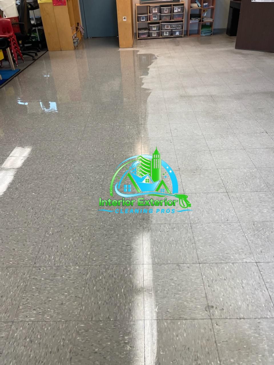 A tiled floor in a room with a logo on it.