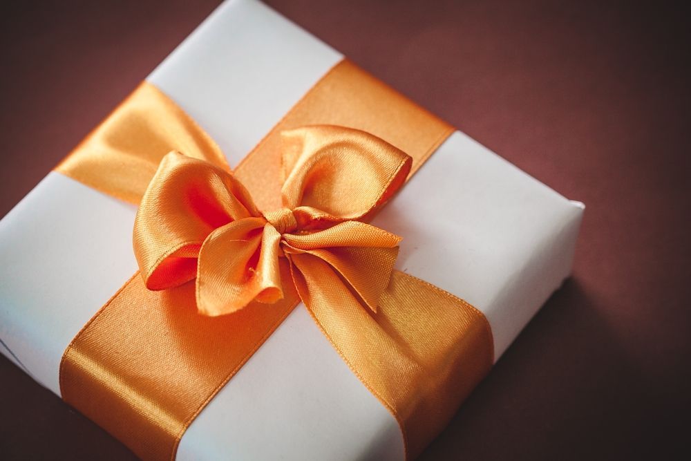 A Row of White Boxes with Pink Ribbons and Bows — Barnyard Stockfeed, Pet, Garden and Florist in Childers, QLD