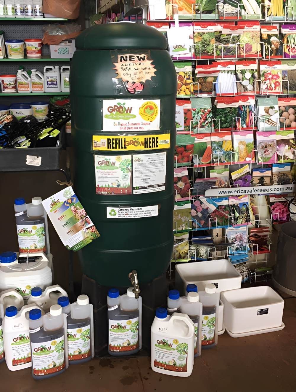 A Green Water Tank is Surrounded by Bottles — Barnyard Stockfeed, Pet, Garden and Florist in Childers, QLD