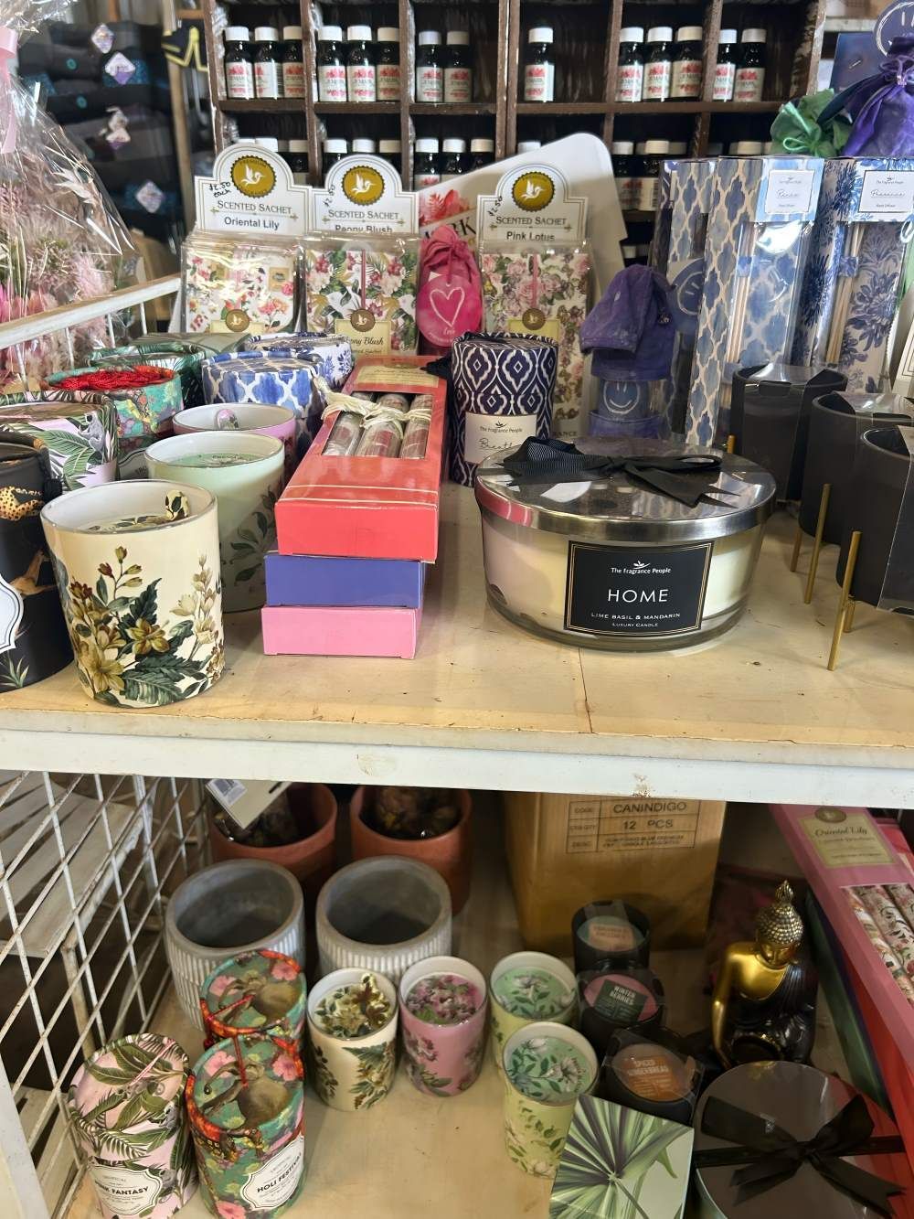 A Shelf Filled With Candles and Pots in a Store — Barnyard Stockfeed, Pet, Garden and Florist in Childers, QLD