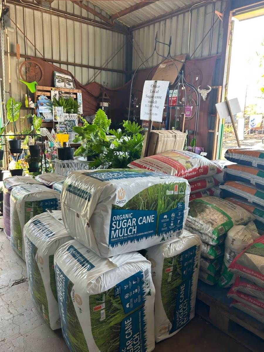 A Warehouse Filled With Lots of Bags of Mulch and Plants — Barnyard Stockfeed, Pet, Garden and Florist in Childers, QLD