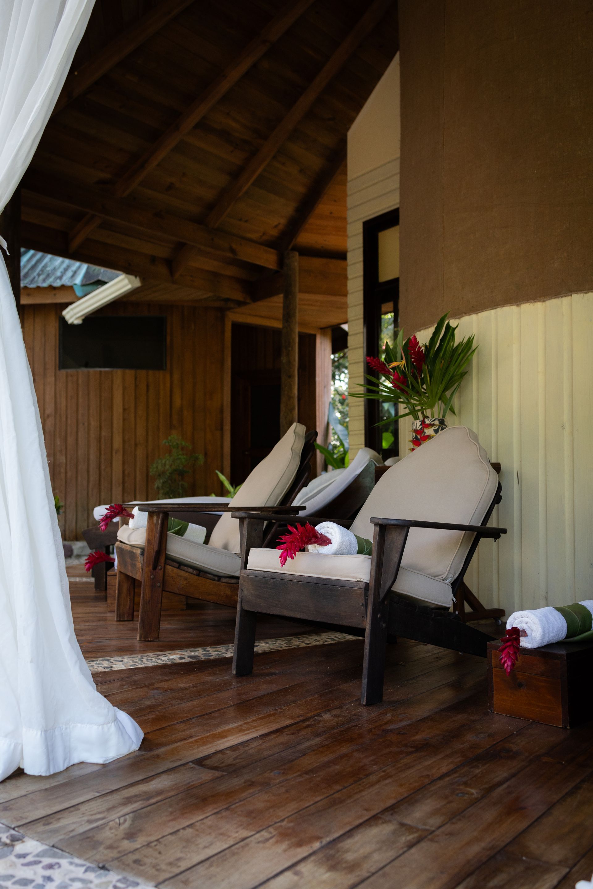 A wooden deck with two chairs and a couch