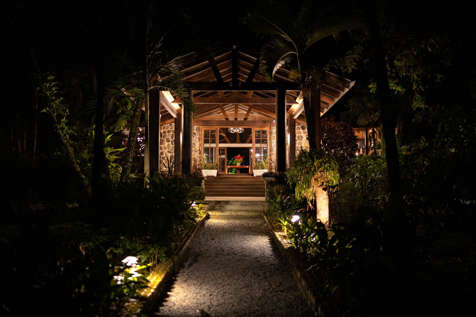 The entrance to a house is lit up at night.