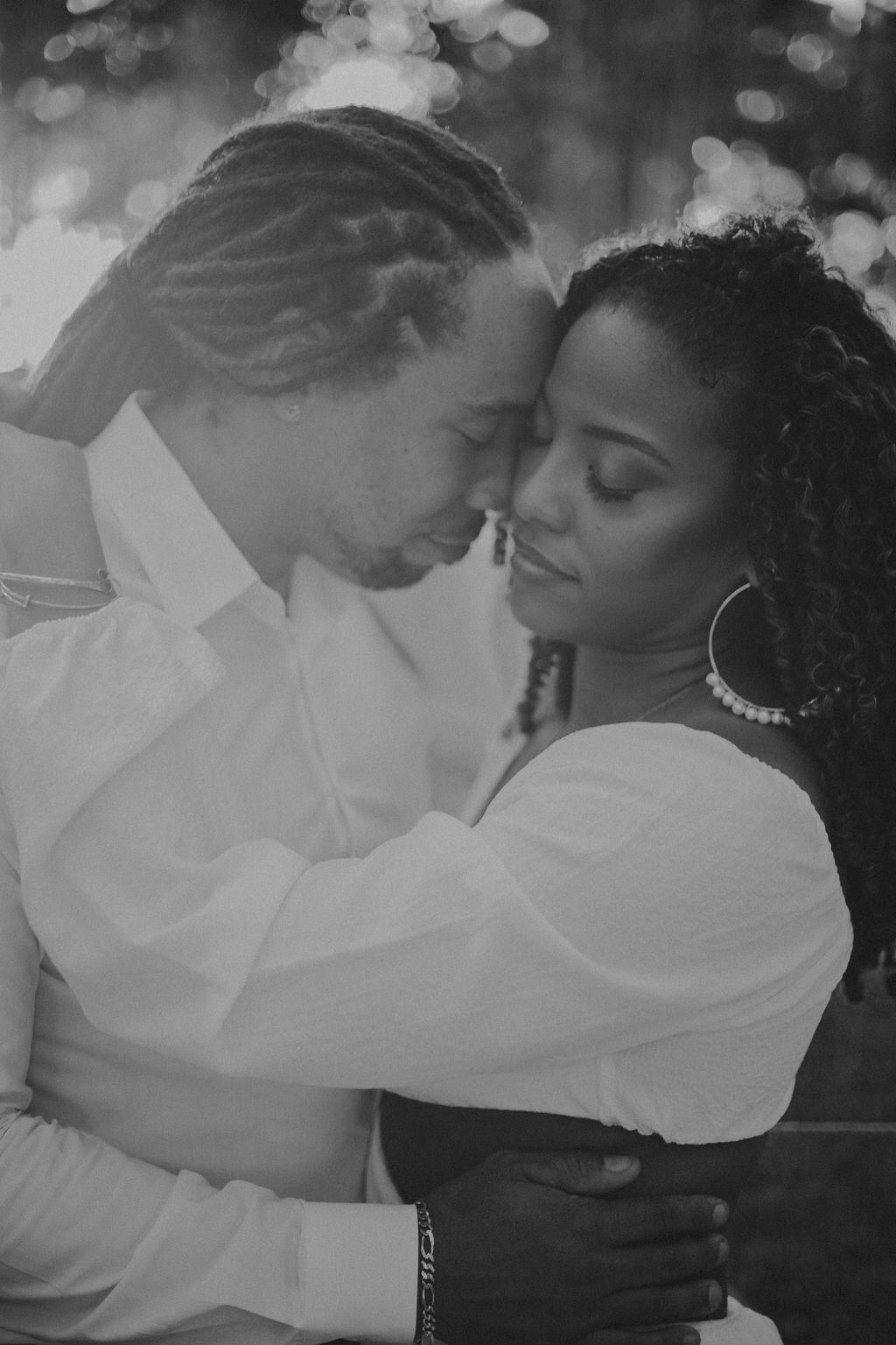 A black and white photo of a man and woman hugging each other.