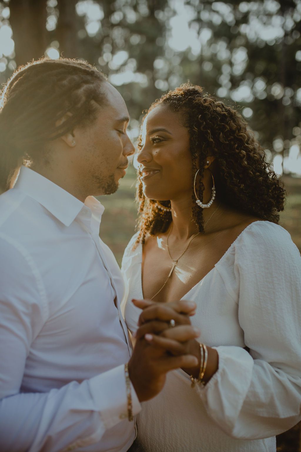 A man and a woman are holding hands and looking at each other.