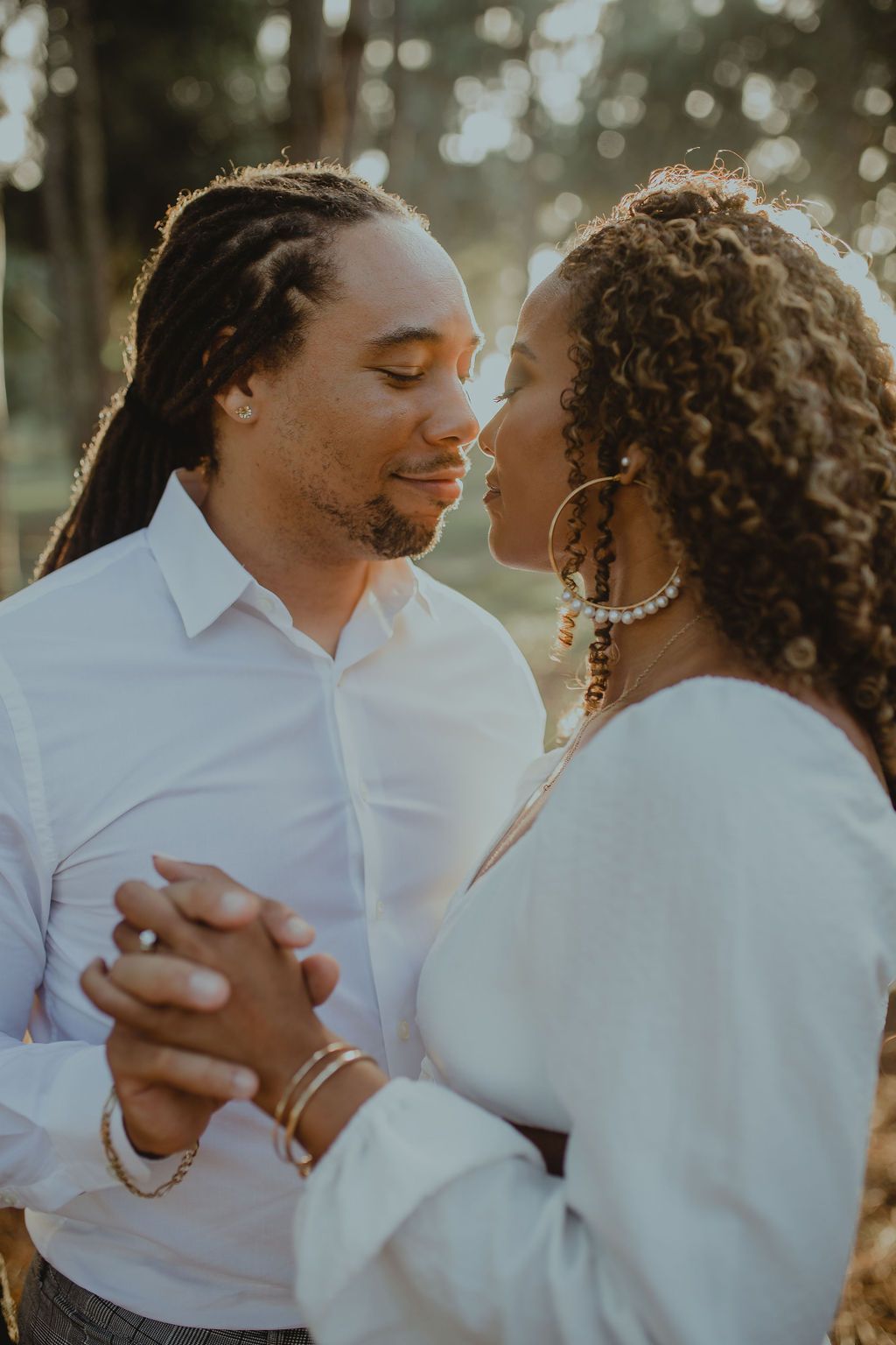 A man and a woman are holding hands and looking at each other.