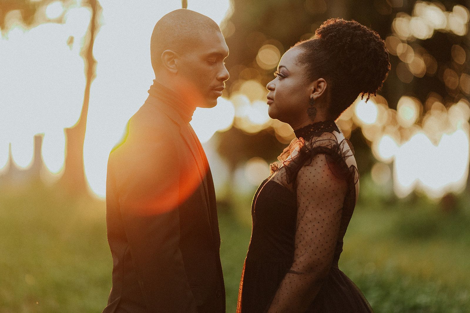A man and a woman are looking at each other in a field.