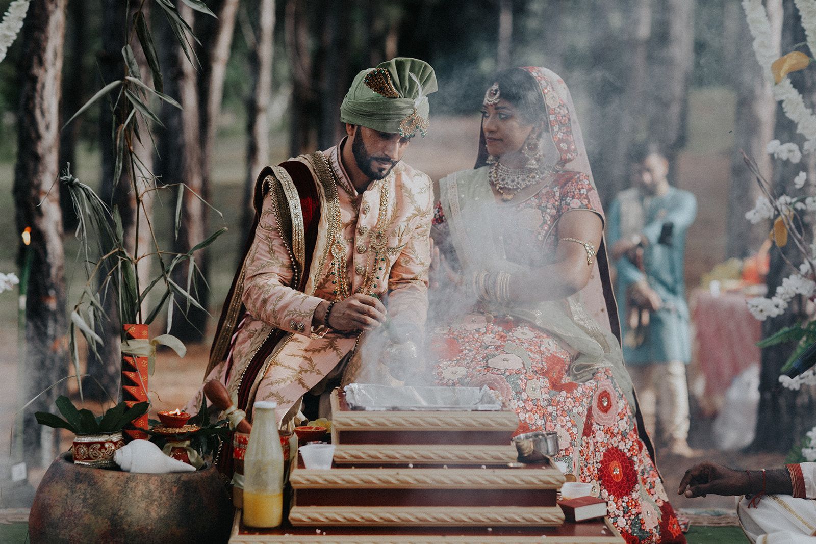 A bride and groom are sitting next to each other at a wedding ceremony.