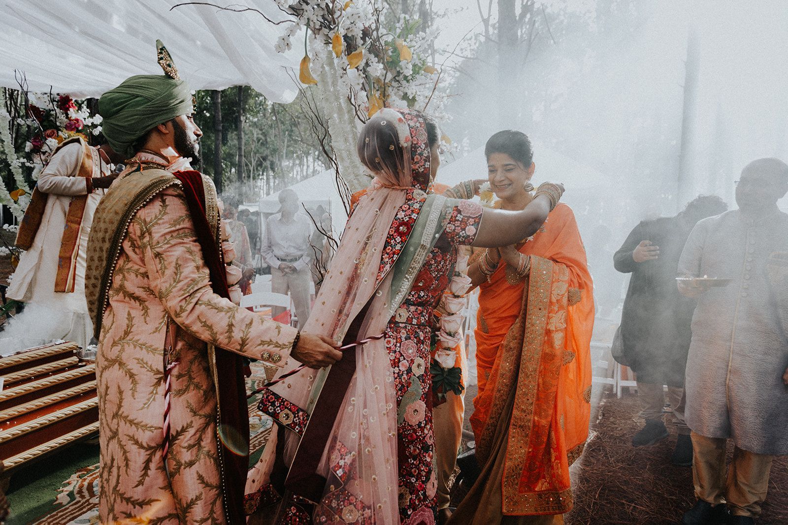 A bride and groom are standing next to each other at a wedding ceremony.