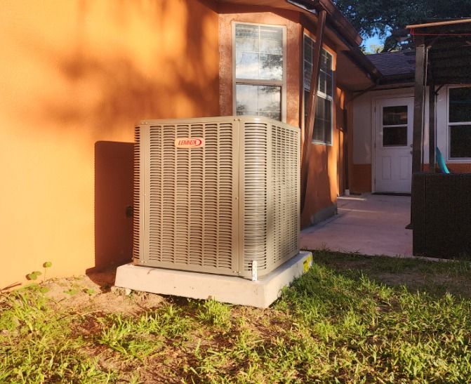 A carrier air conditioner is sitting outside of a house