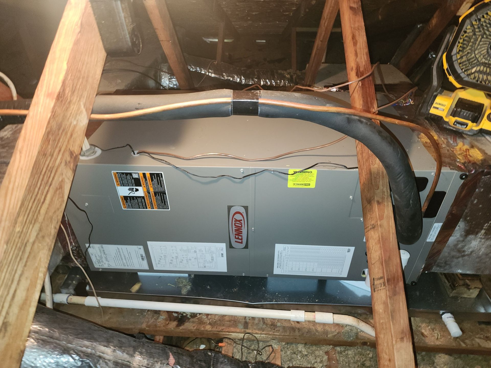 An air conditioner is installed in the attic of a house.