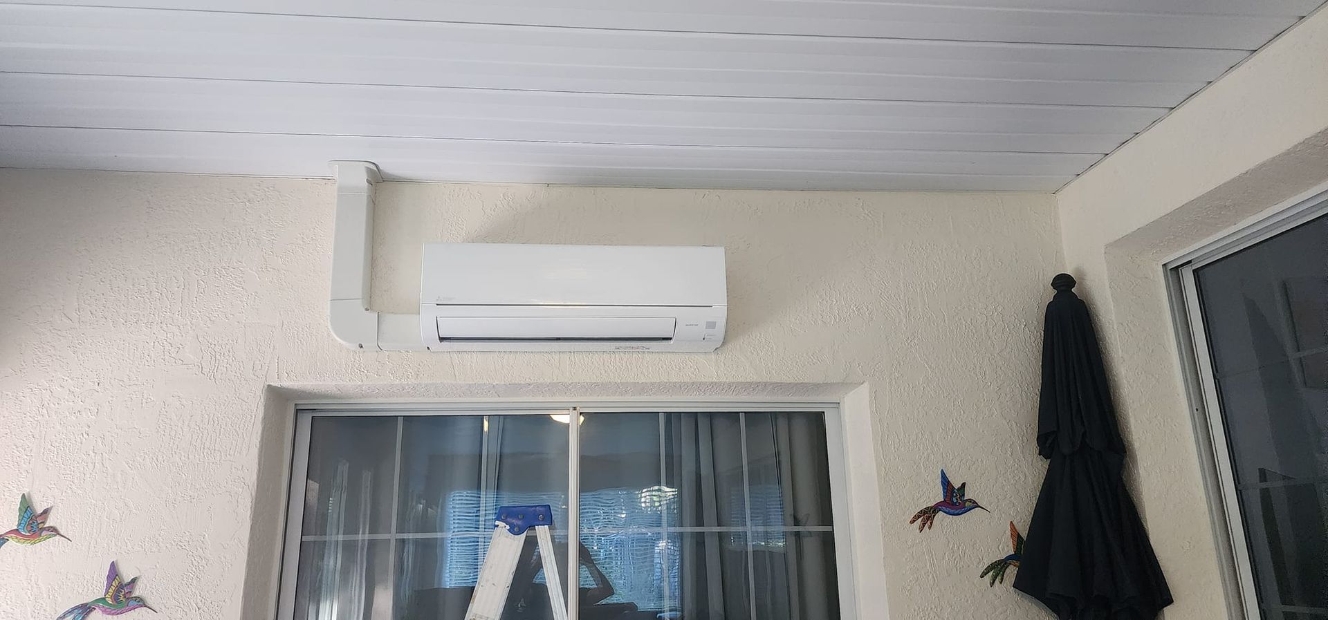 A room with a ceiling fan and a window.