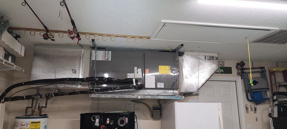 A garage with a ceiling fan and a water heater.