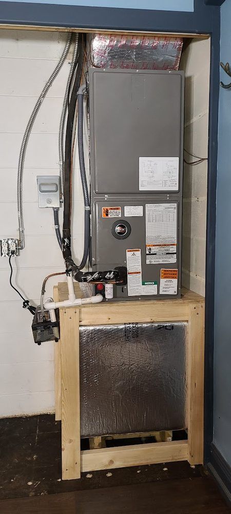 An air conditioner is sitting on top of a wooden table in a room.