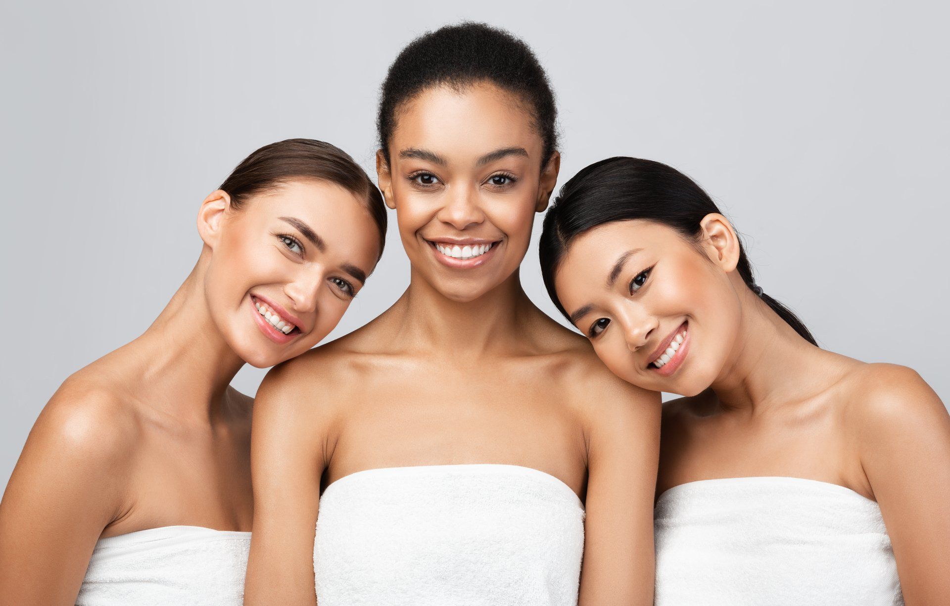 three multiracial women posing