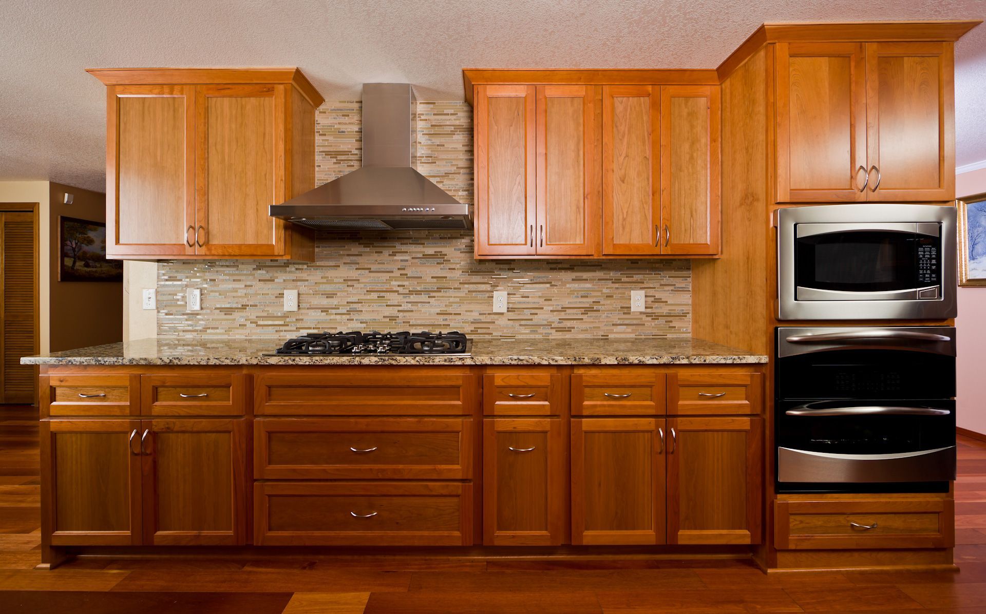 A kitchen with wooden cabinets and stainless steel appliances