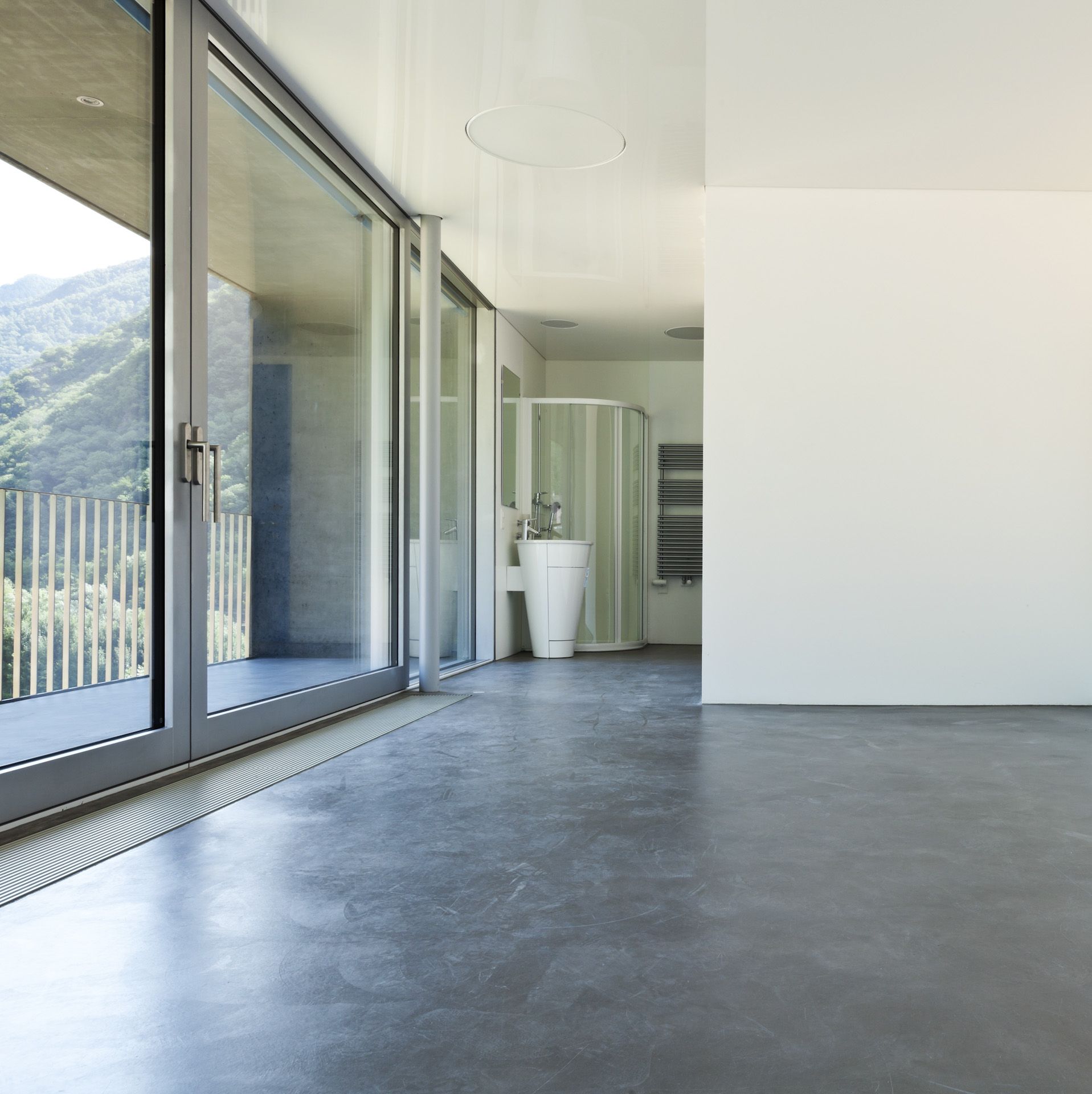 A bathroom with concrete flooring