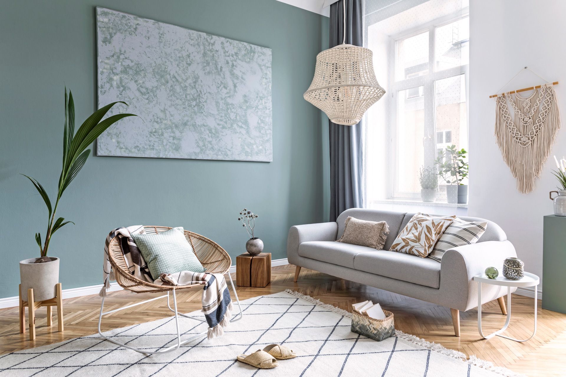 A living room with a couch , chair , rug and painting on the wall.