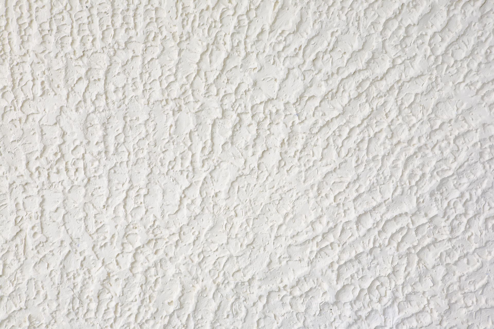 A close up of a white wall with a rough texture.