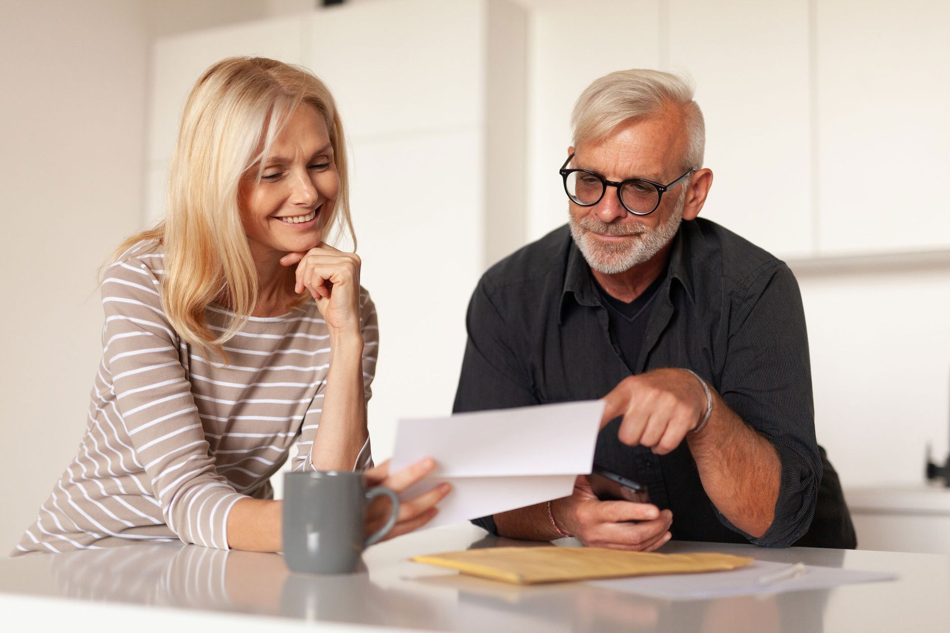 Old Couple Holding A Document — Pensacola, FL — Integrity Financial Group