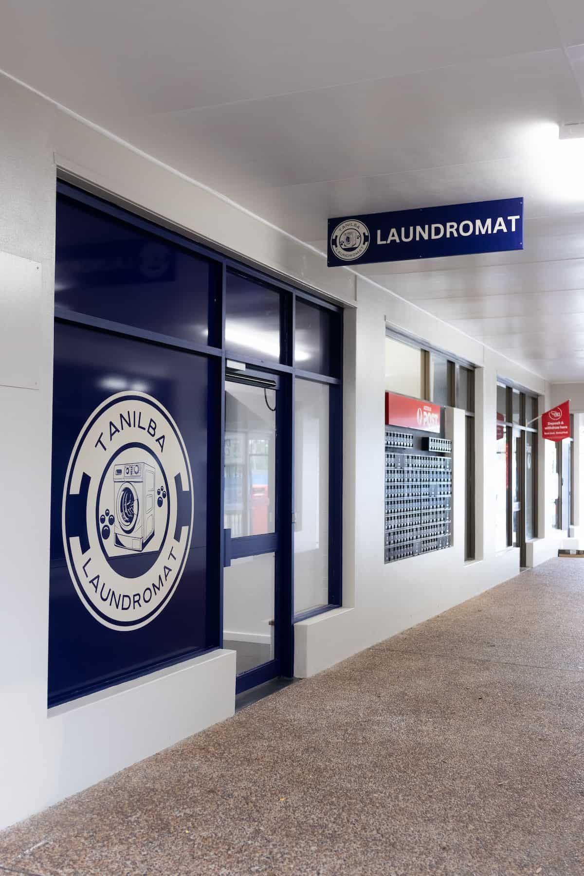 A Laundromat Is Located In A Building With A Sign Above It— Tanilba Bay Laundromat In Tanilba Bay, NSW